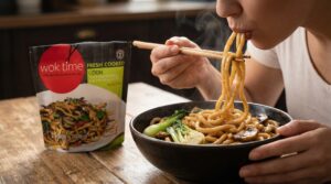 Woman with ready-to-eat noodles | Wok Time by Thoroughfair
